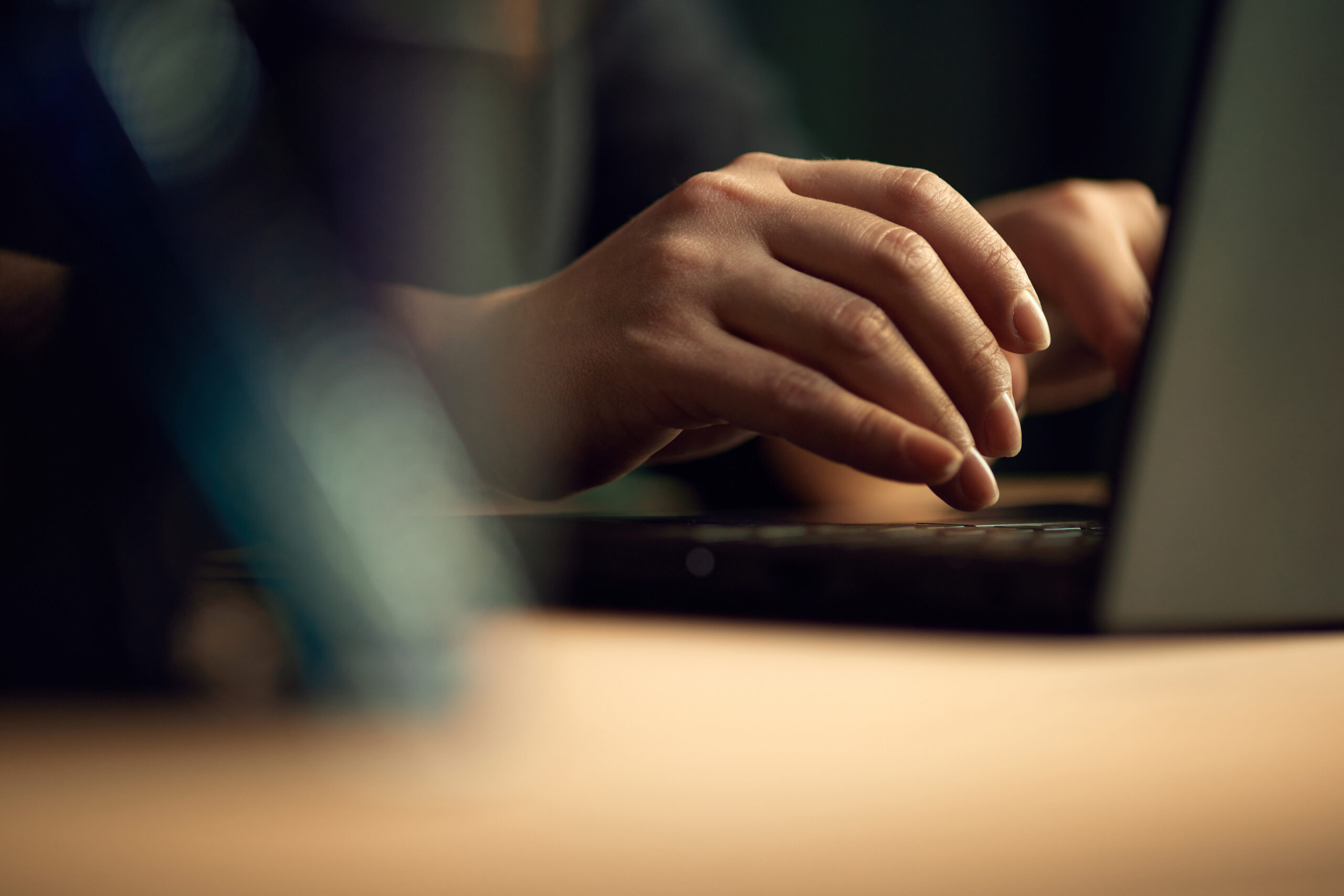 Close-up image of female hands typing on keyboard. Business woman working on laptop, making projects