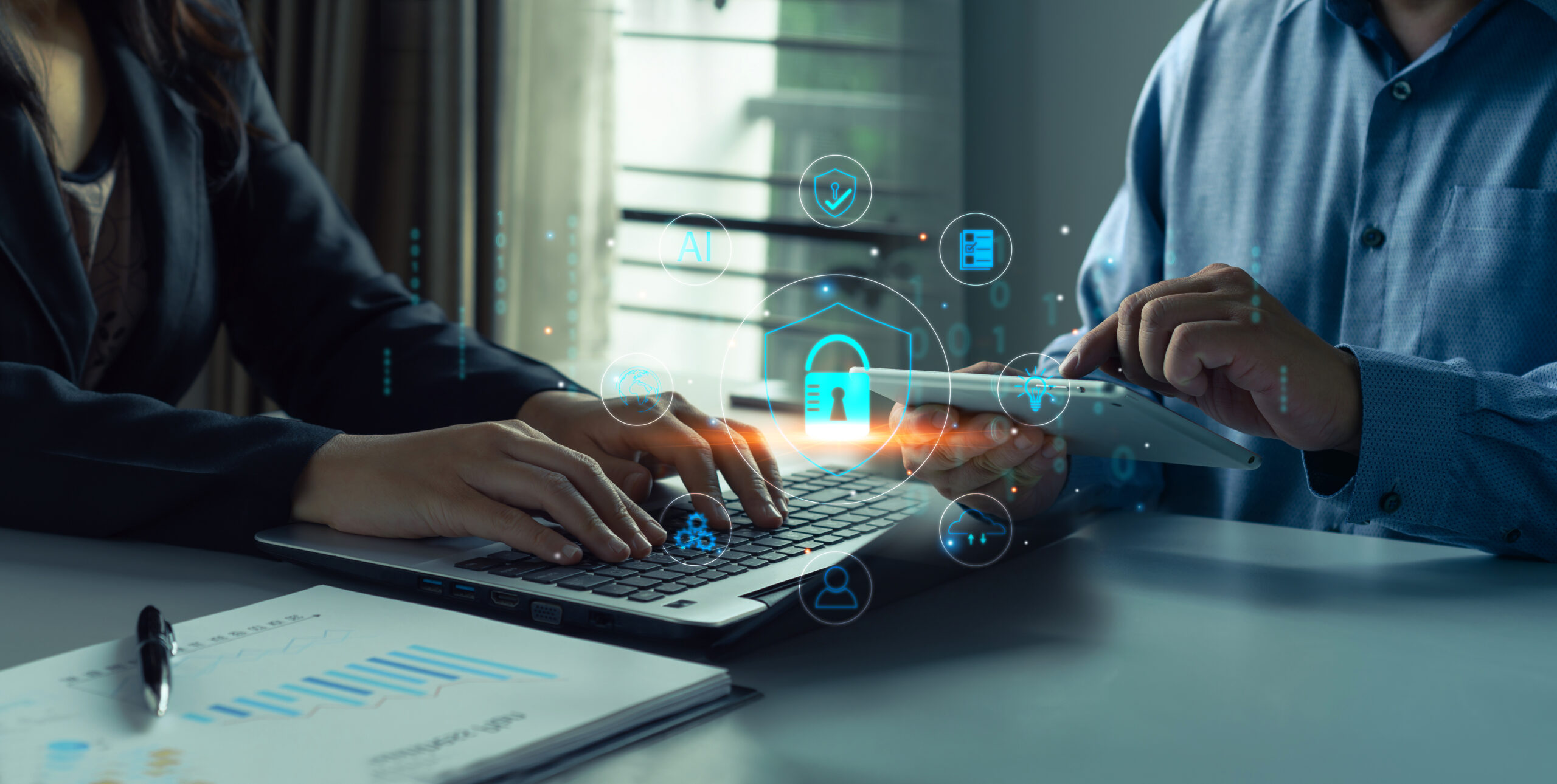 Cyber security and data protection.Business professionals collaborating on cybersecurity using laptop and tablet, with digital icons illustrating secure data protection private data security