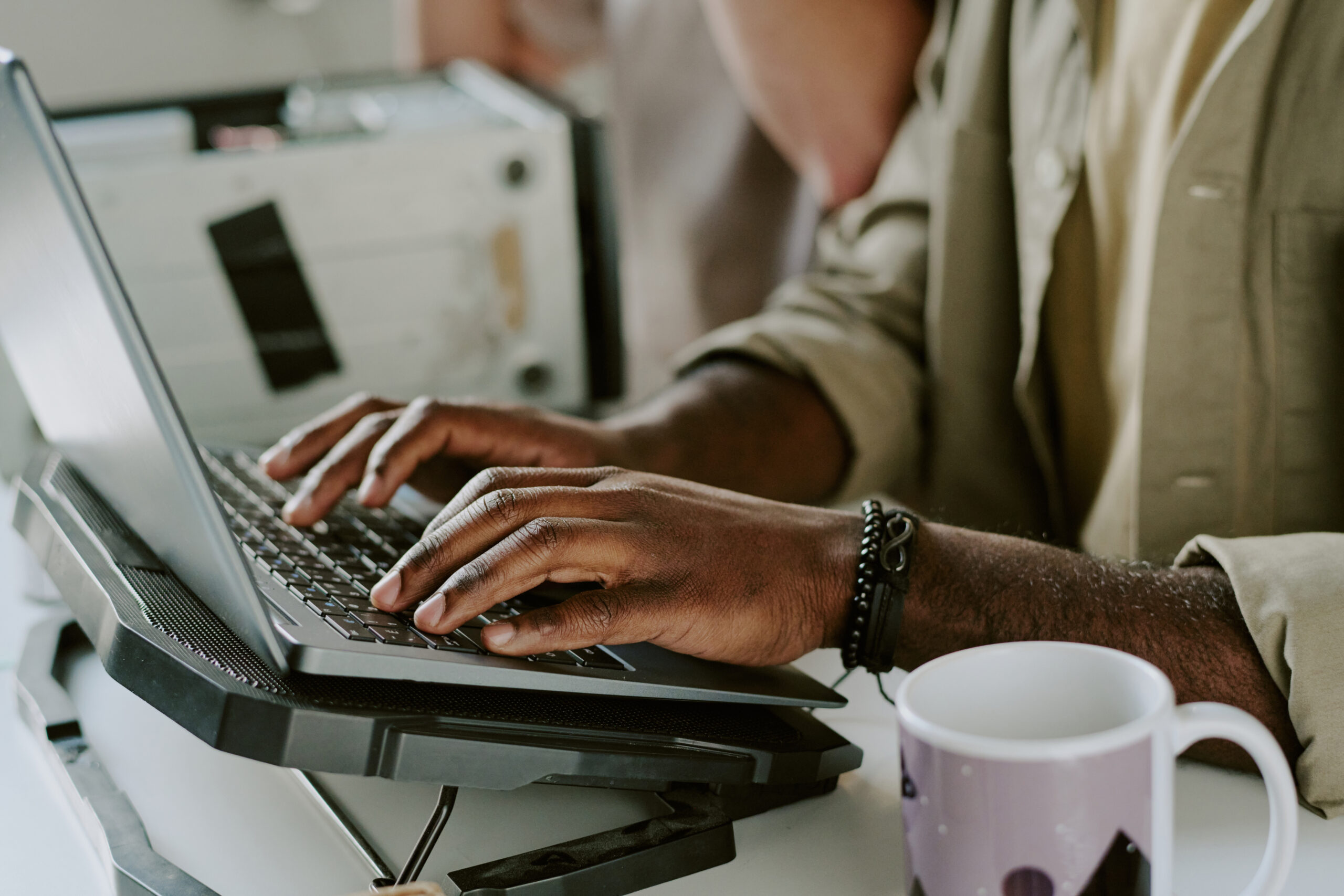 Male Hands on Keyboard of Laptop